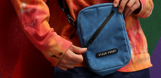 Woman holding Stash bag and unzipping it by waterproof zipper