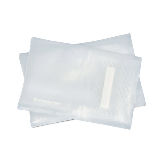 A stack of 8 by 12 inch clear vacuum seal bags stacked on top of each other and fanned out