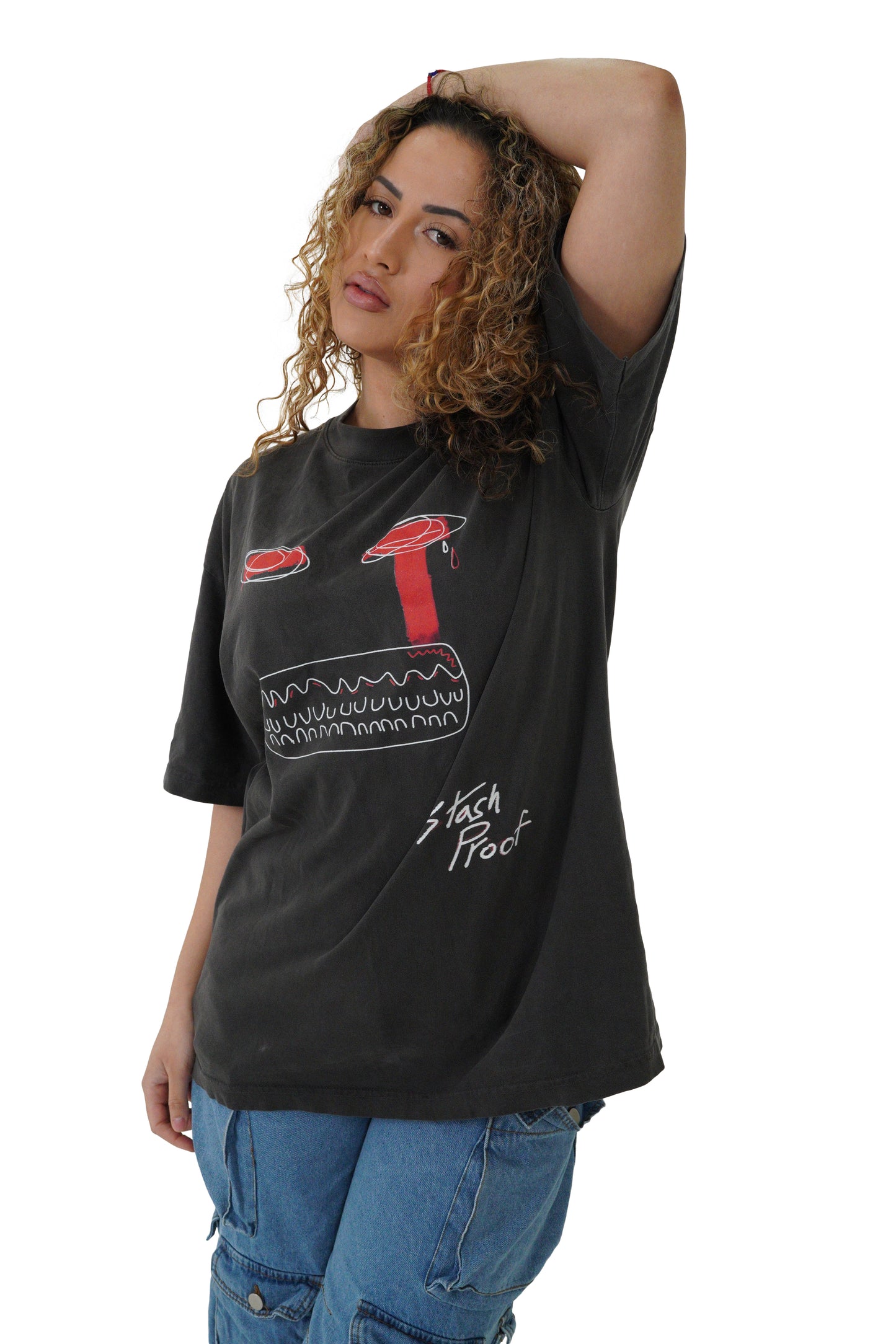 A woman with dark and blonde curly hair wearing a black shirt with black Limited Masquerade t-shirt
