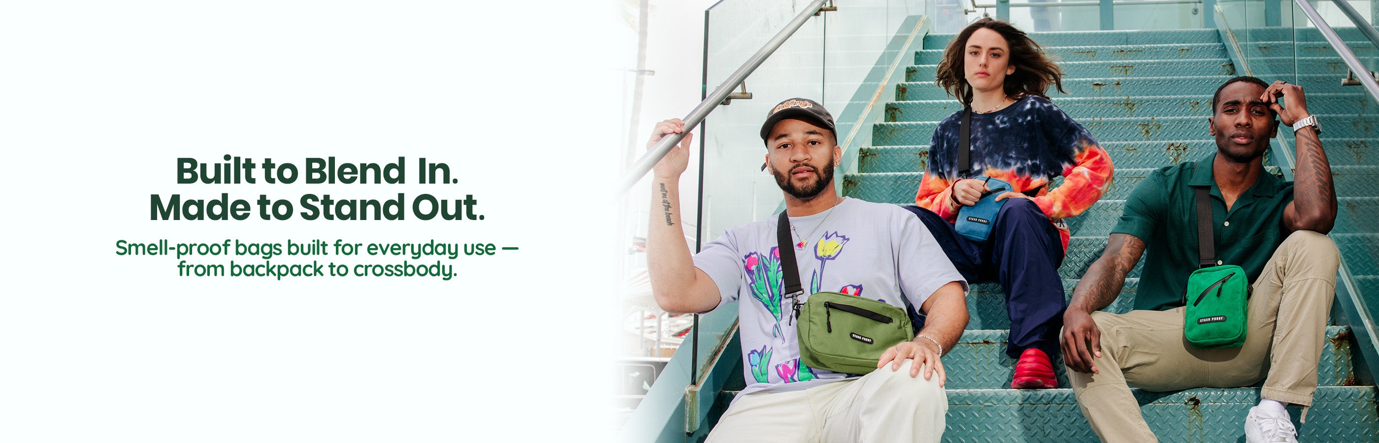 Two men and a woman sitting on green metal steps wearing smell proof crossbody bags by Stash Proof
