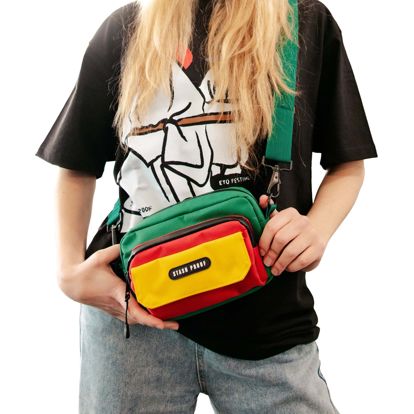 Person holding a colorful crossbody bag with visible brand name.