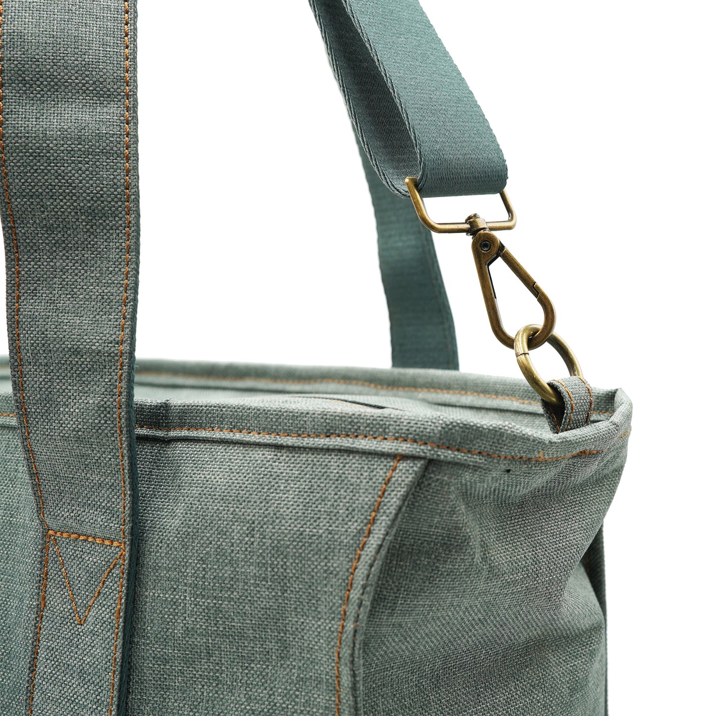 Closeup of brass hardware and strap on tote bag.