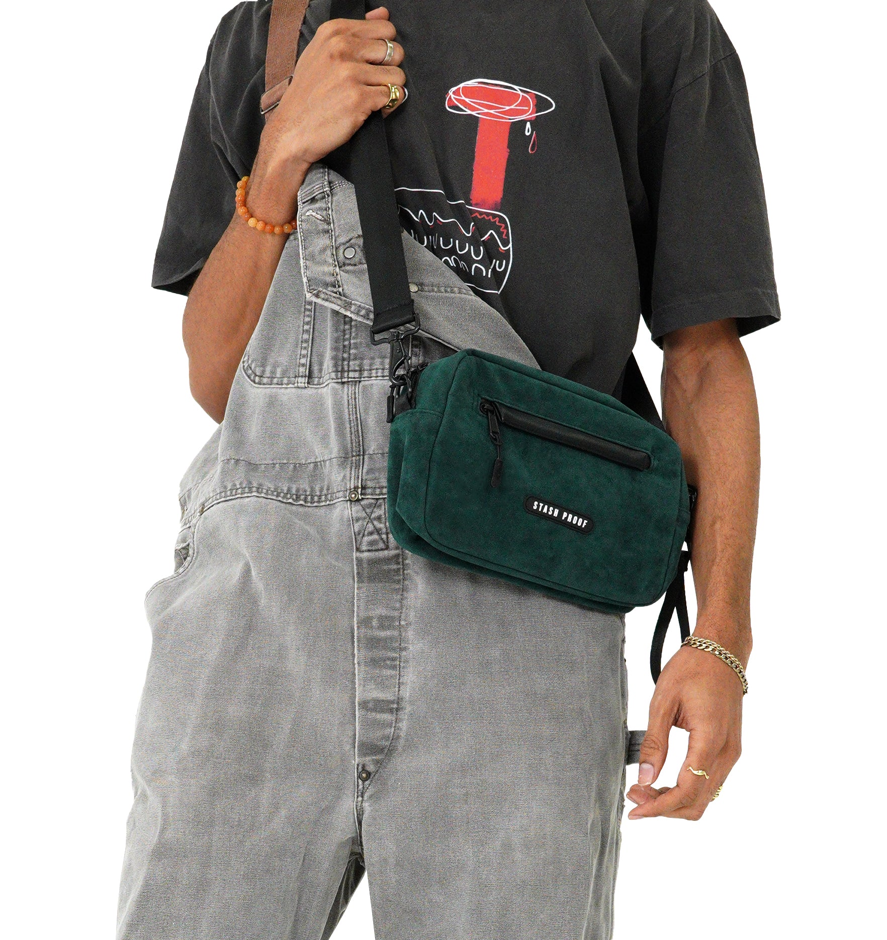 Male model from shoulder down in gray overalls carrying dark green Rover bag