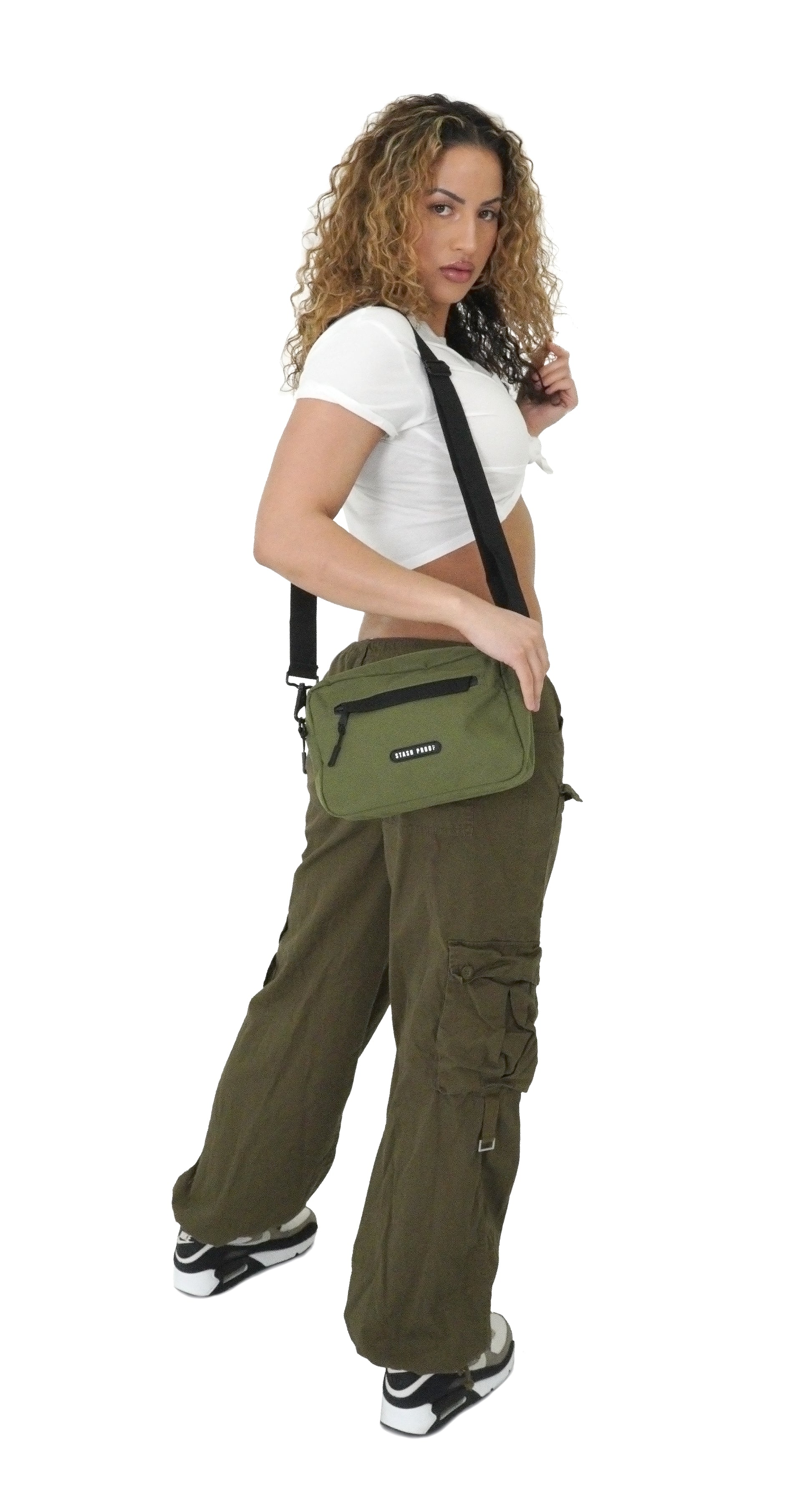 Female model with dark curly hair holding green Stash Proof smell proof Rover bag