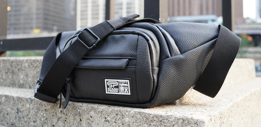 Transporter fanny pack belt bag and crossbody sitting outside