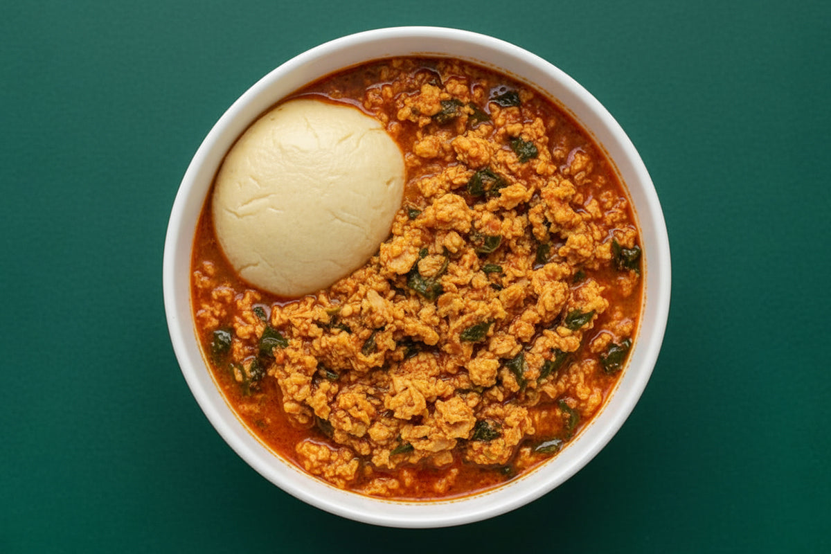 Bowl of egusi with a large ball of fufu on a green background