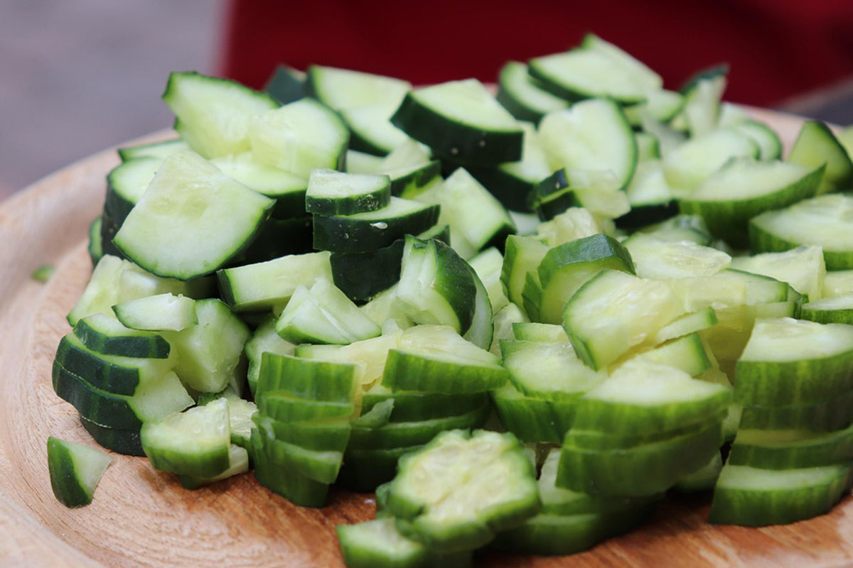 Diced cucumbers on a wooden cutting board
