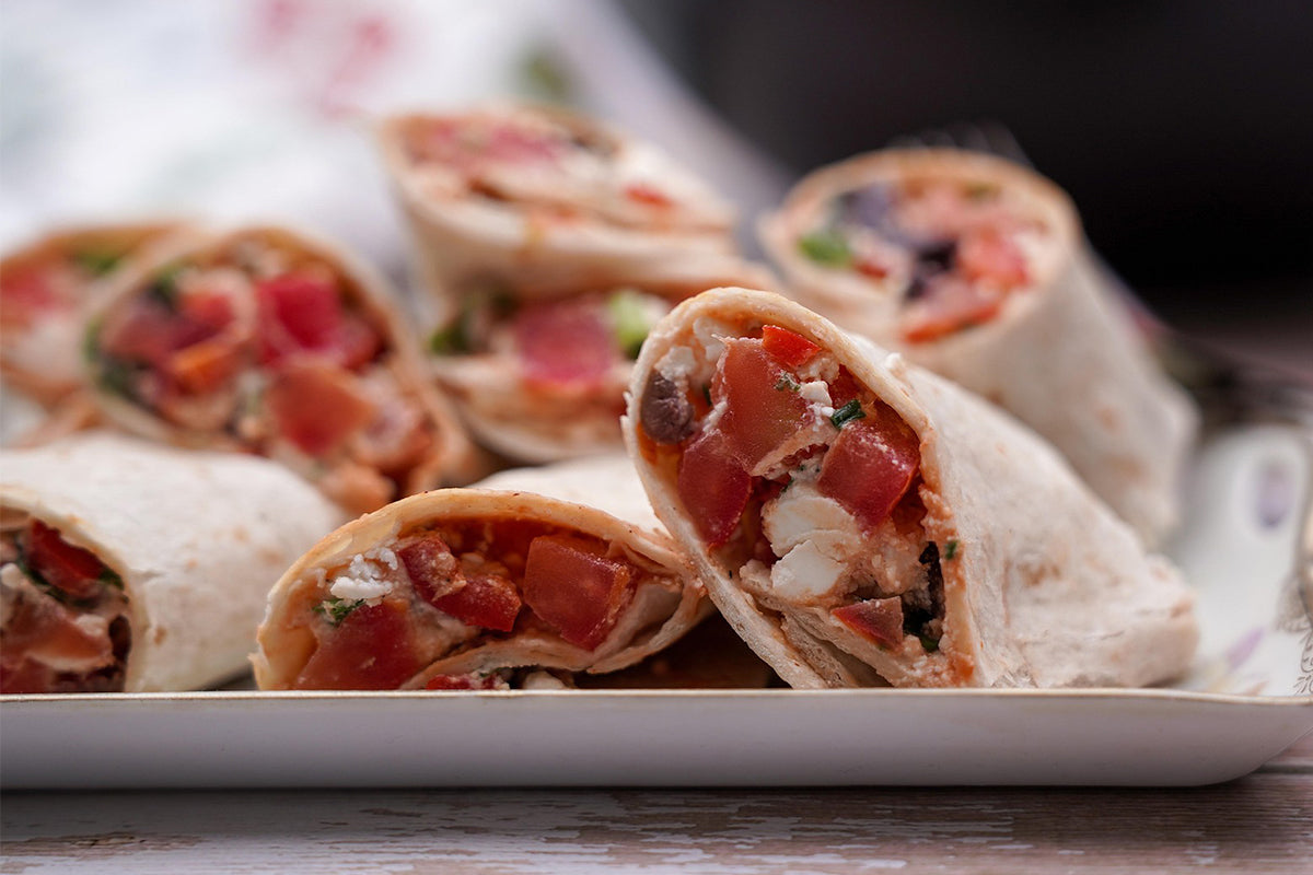 Close-up of chickpea wrap with visible ingredients on a plate