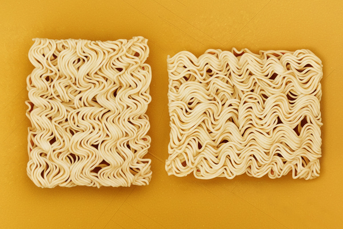 Two square blocks of wavy noodles on a yellow background