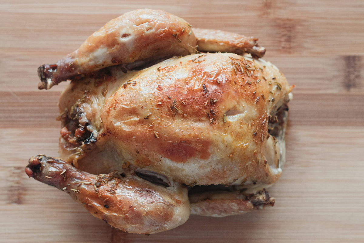Roasted chicken on a wooden cutting board