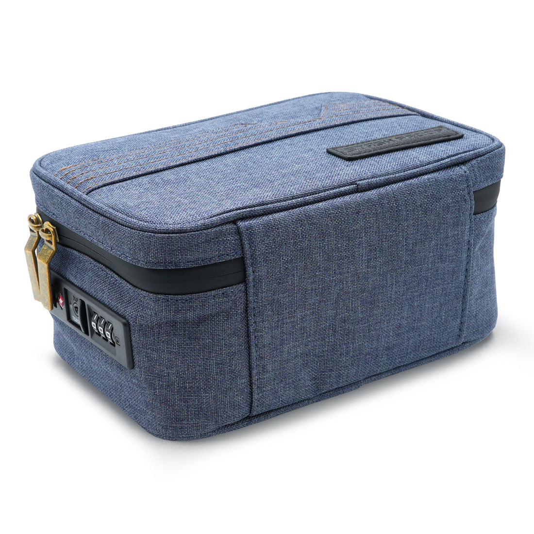 Close view of the built-in combination TSA lock and brass zipper hardware on the denim blue Stash Pack