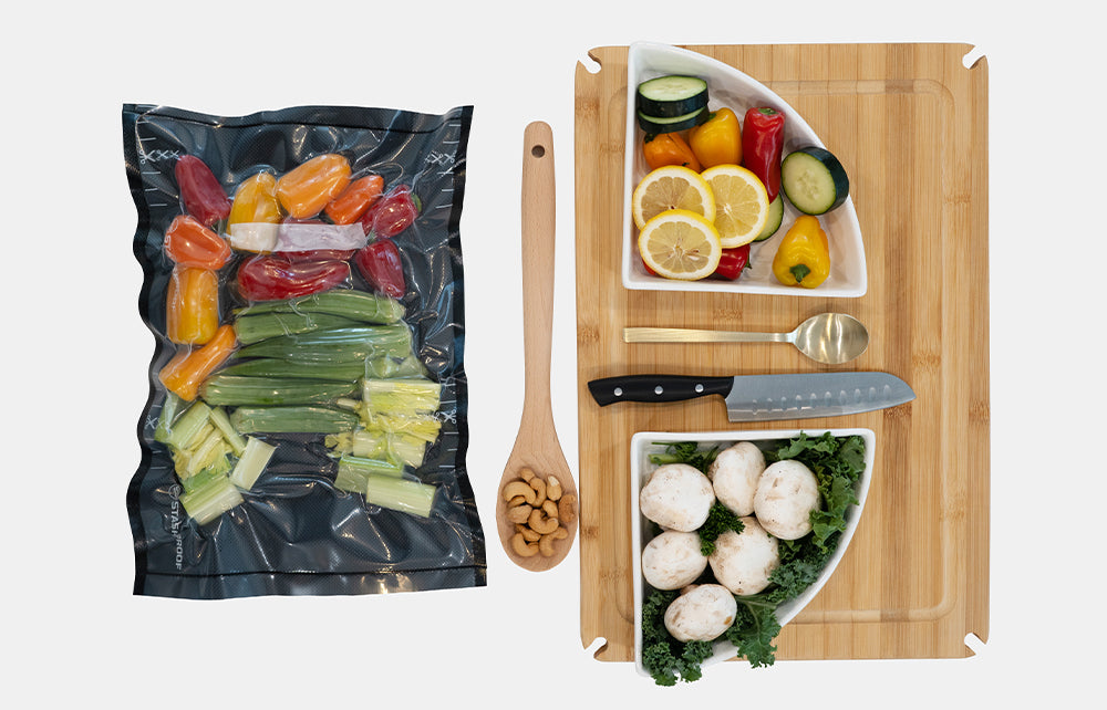 Vacuum-sealed food package, wooden cutting board with vegetables, and kitchen utensils on a white background