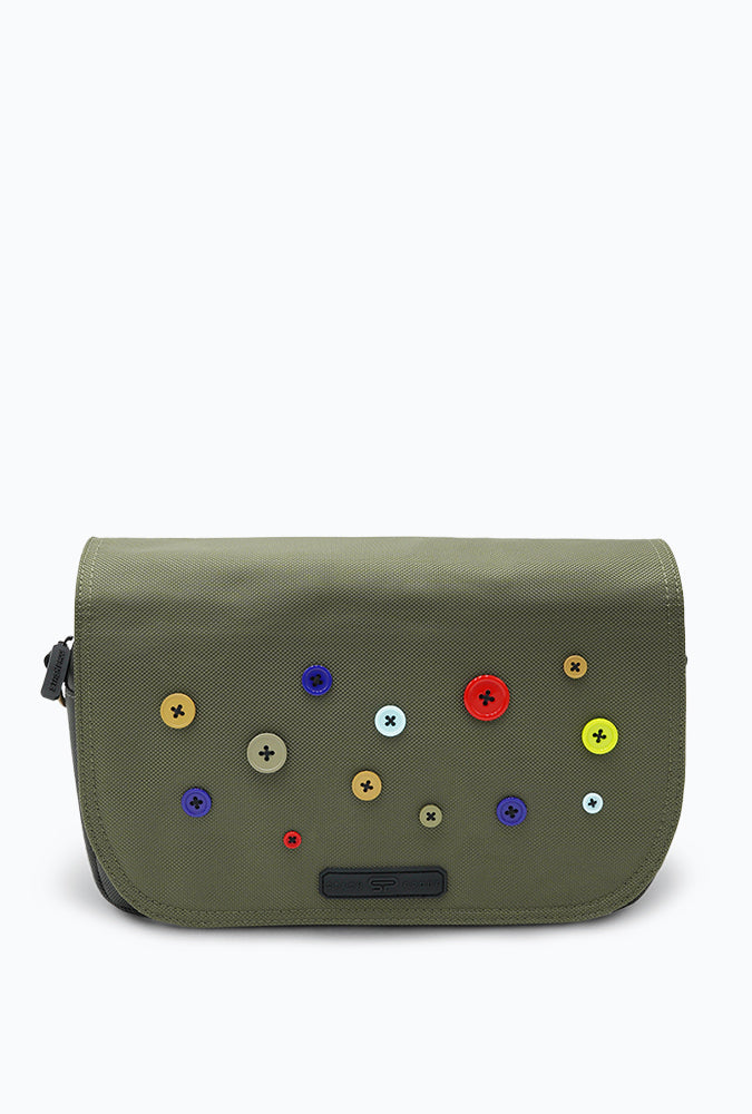 Button Bag crossbody by Stash Proof sitting on white background, various color buttons decorate the front of bag