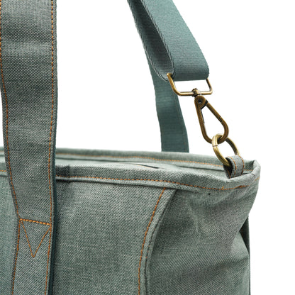 Closeup of brass hardware and strap on tote bag.