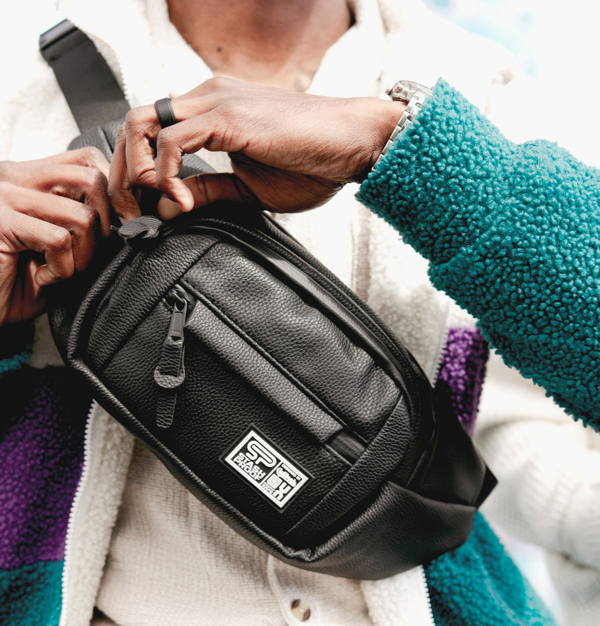 Model wearing the black Transporter vegan-leather crossbody bag