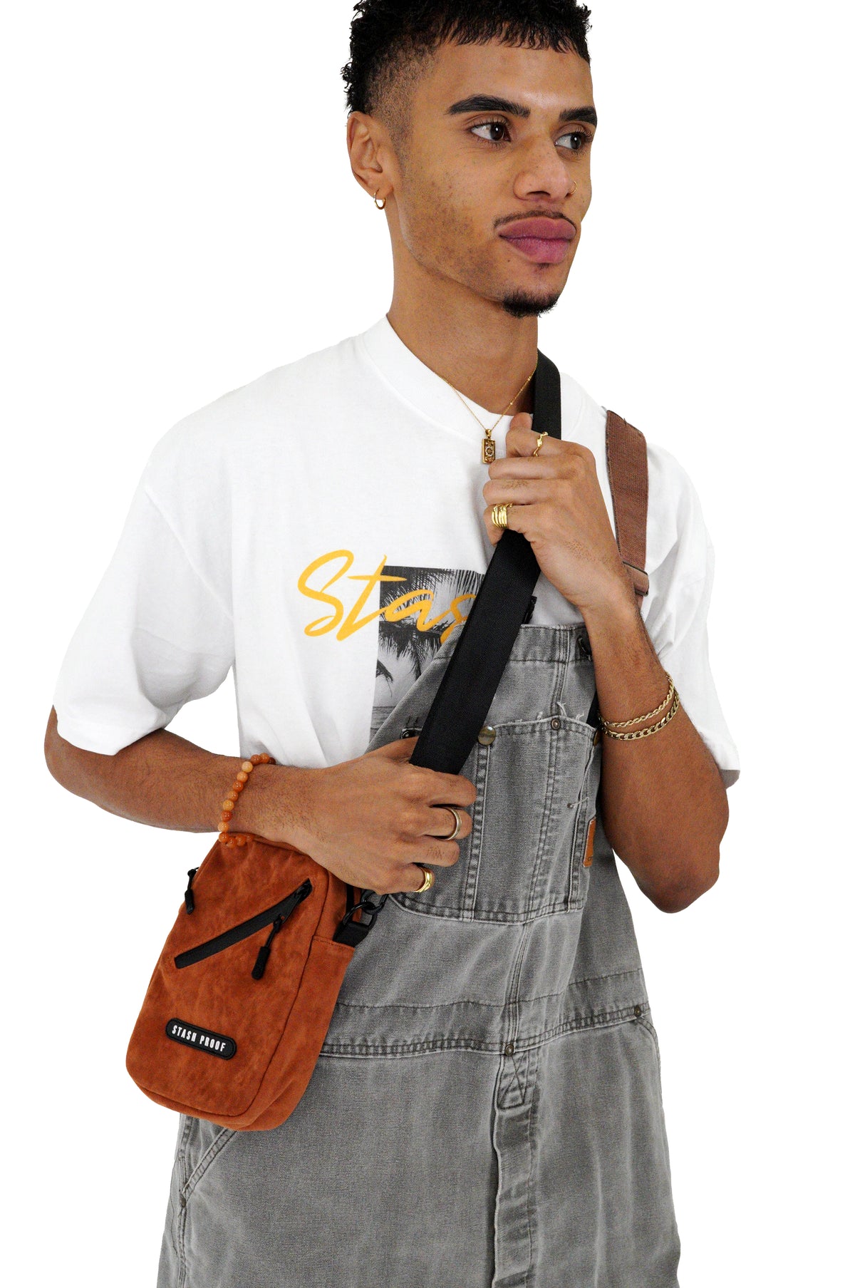 Model wearing the brown suede Stash Bag as a compact crossbody bag