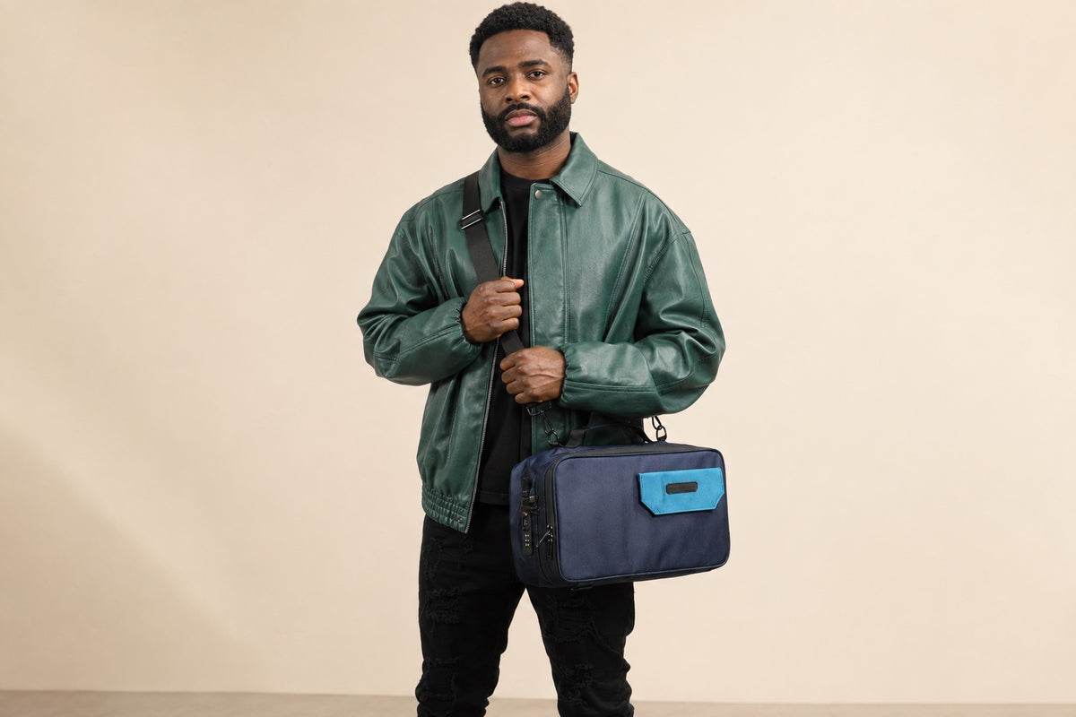 Model carrying the navy and light blue Stash Box with its detachable shoulder strap