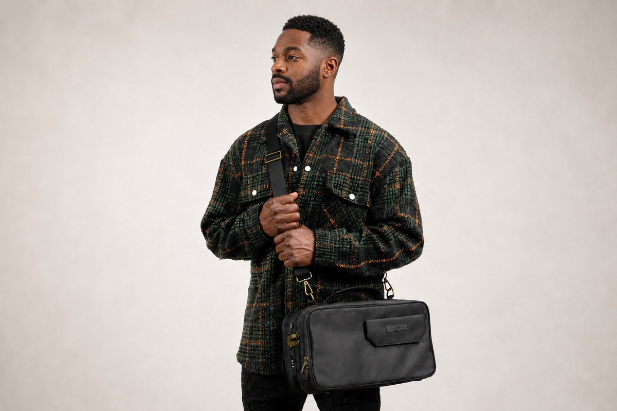 Model carrying the black Stash Box with its detachable shoulder strap